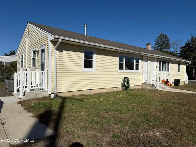 a view of a white house with a yard