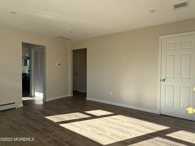 an empty room with wooden floor