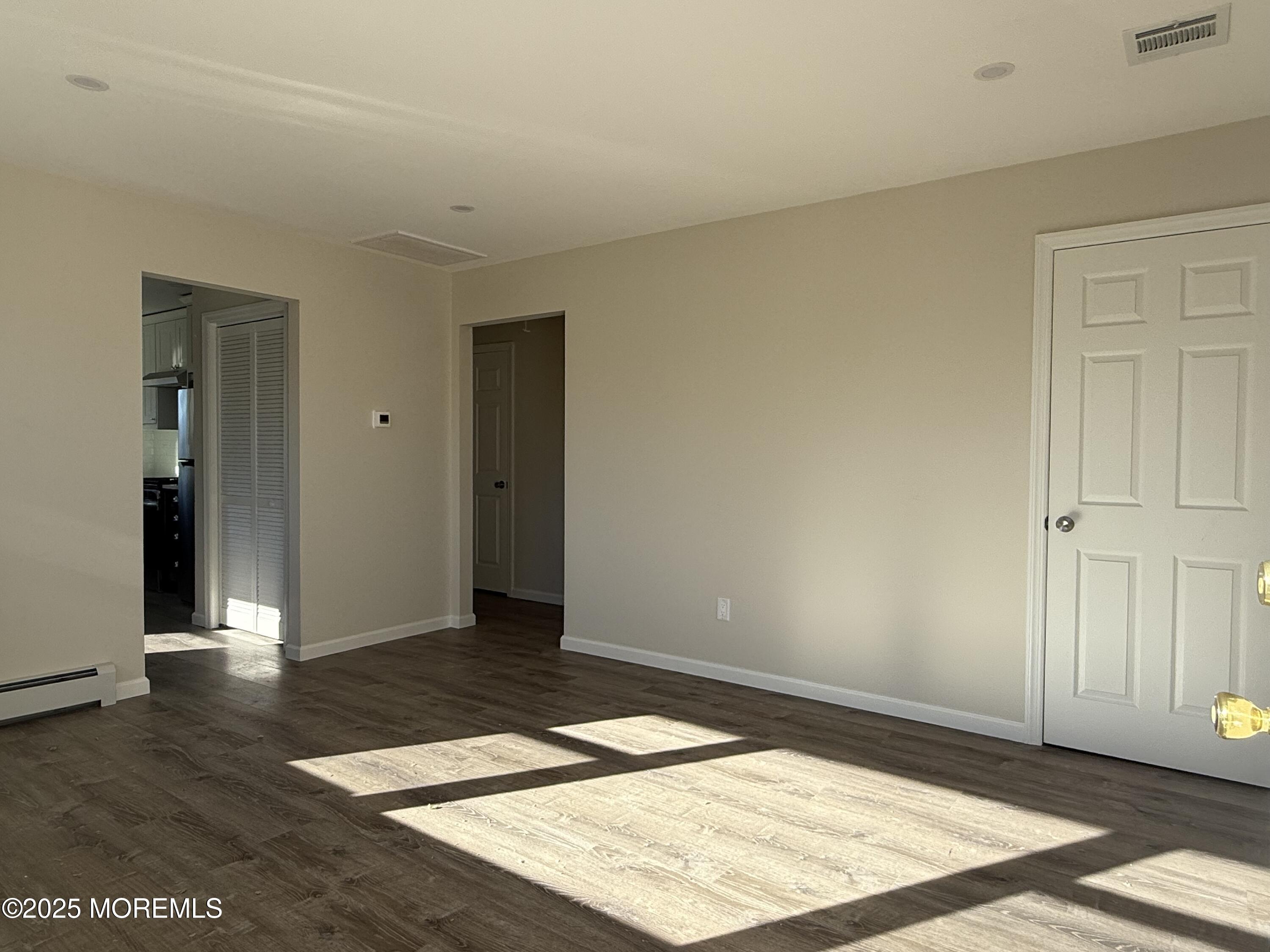 616 Ocean Gate Avenue, Unit 5 Ocean Gate, NJ 08740 - Photo 6 of 15 an empty room with wooden floor