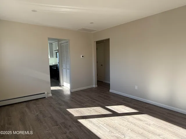 a view of an empty room and wooden floor