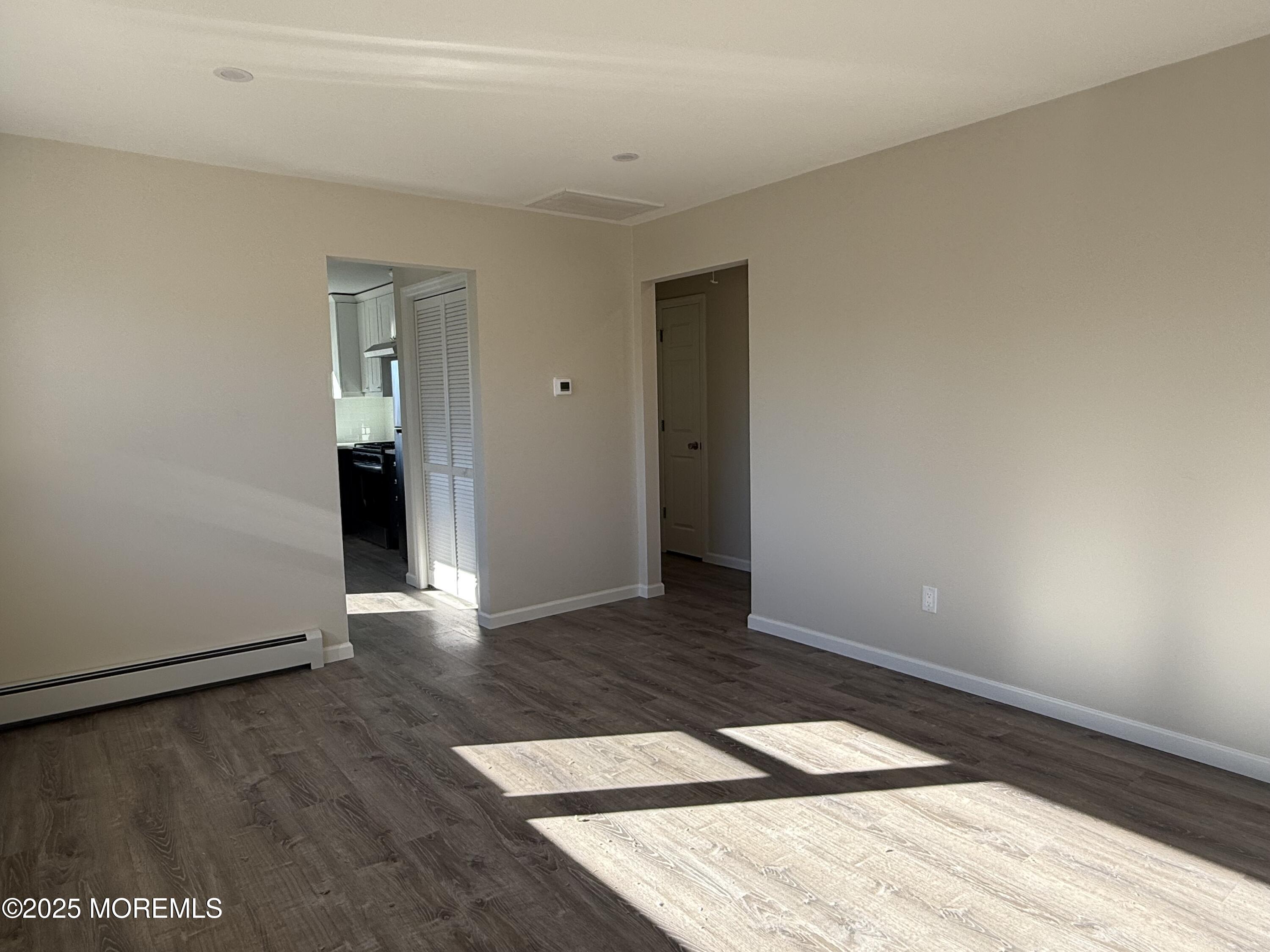 616 Ocean Gate Avenue, Unit 5 Ocean Gate, NJ 08740 - Photo 7 of 15 a view of an empty room and wooden floor