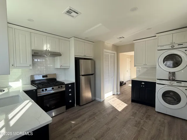 a kitchen with kitchen island wooden cabinets and stainless steel appliances