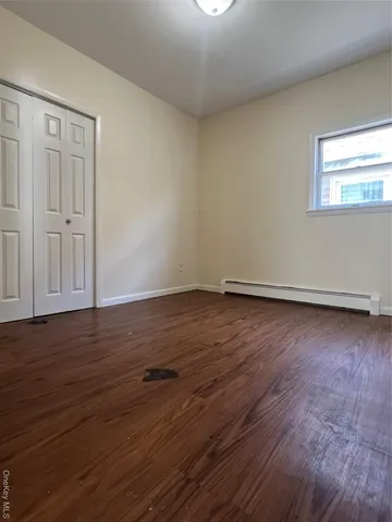 a view of wooden floor and windows in a room
