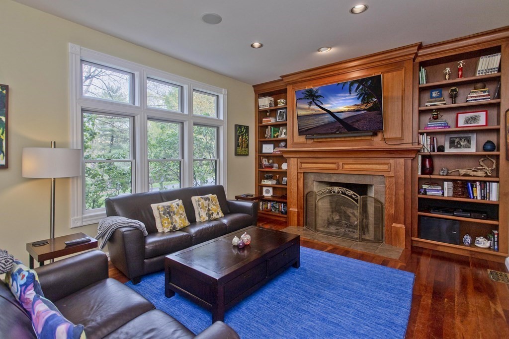 31 Rustlewood Ridge Northampton, MA 01062 - Photo 17 of 42 a living room with furniture a flat screen tv and a fireplace