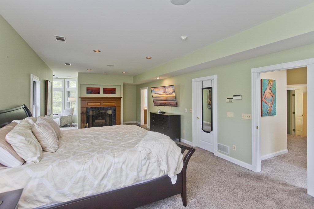 31 Rustlewood Ridge Northampton, MA 01062 - Photo 20 of 42 a spacious bedroom with a bed and a flat screen tv