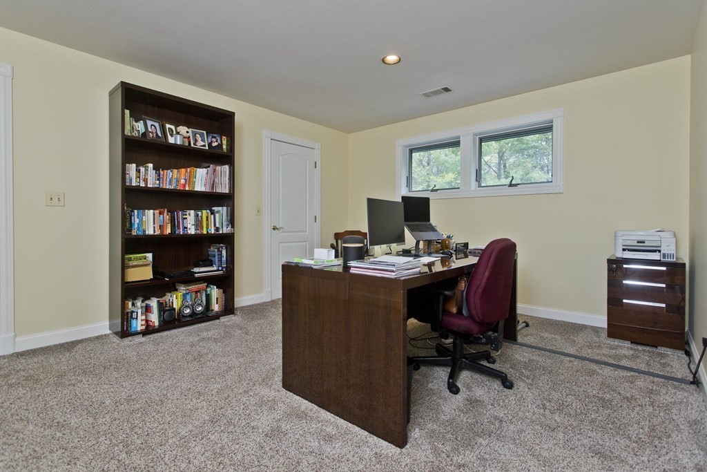 31 Rustlewood Ridge Northampton, MA 01062 - Photo 27 of 42 a view of a workspace with a bookshelf and a chair