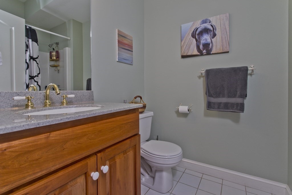31 Rustlewood Ridge Northampton, MA 01062 - Photo 28 of 42 a bathroom with a toilet a sink and mirror