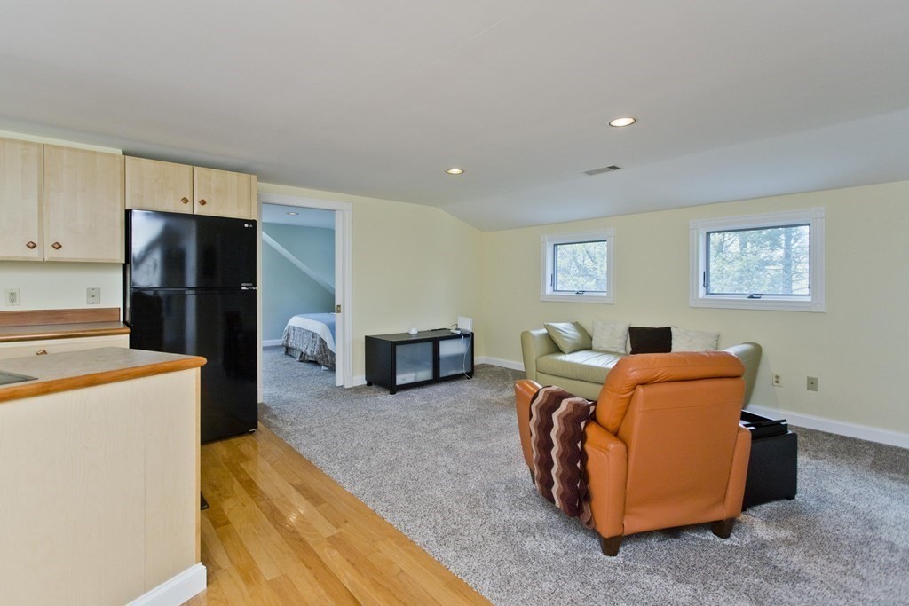 31 Rustlewood Ridge Northampton, MA 01062 - Photo 30 of 42 a living room with furniture and a refrigerator
