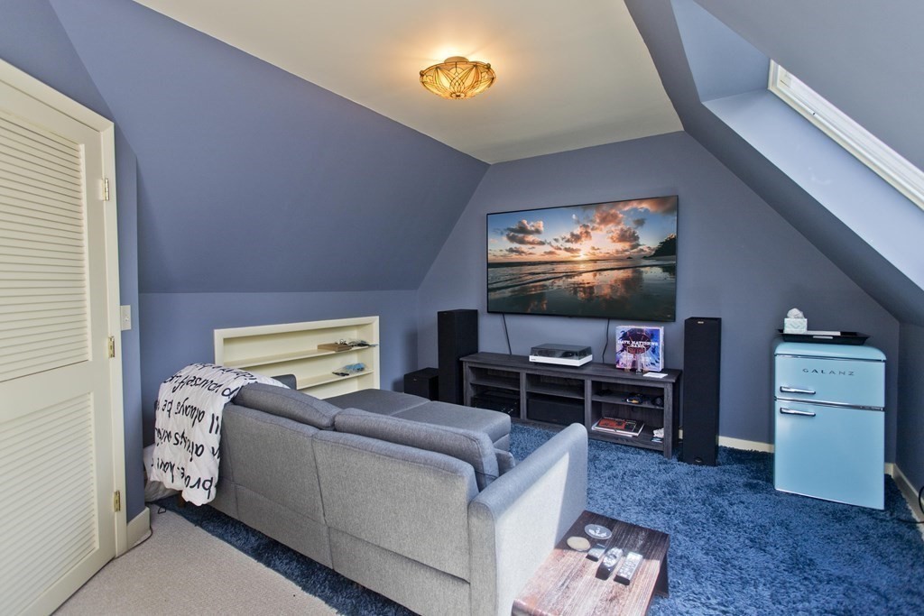 31 Rustlewood Ridge Northampton, MA 01062 - Photo 35 of 42 a living room with furniture and a flat screen tv