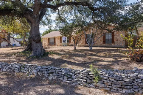 a tree in front of a white house