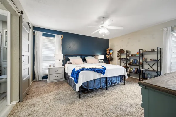 a living room with furniture and a dining table