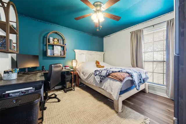 a bedroom with a bed and a flat tv screen