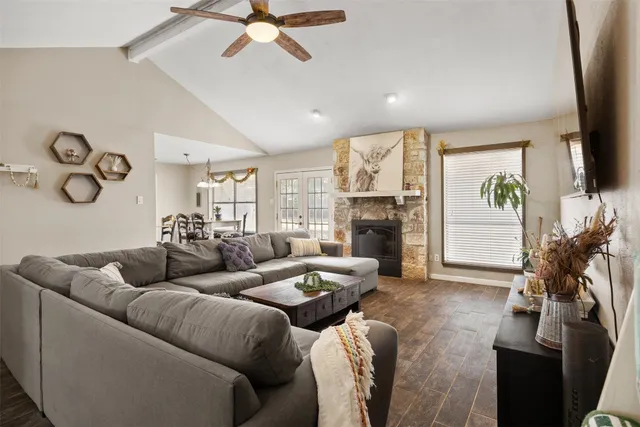 a living room with furniture a fireplace and a flat screen tv