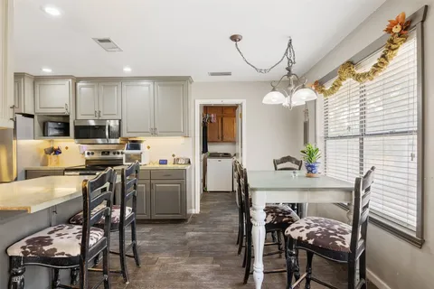 a living room with furniture and view of kitchen