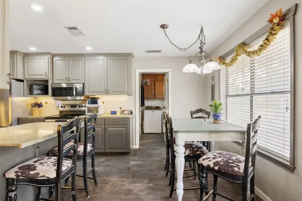 a living room with furniture and view of kitchen