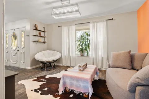 a kitchen with a table chairs refrigerator and microwave