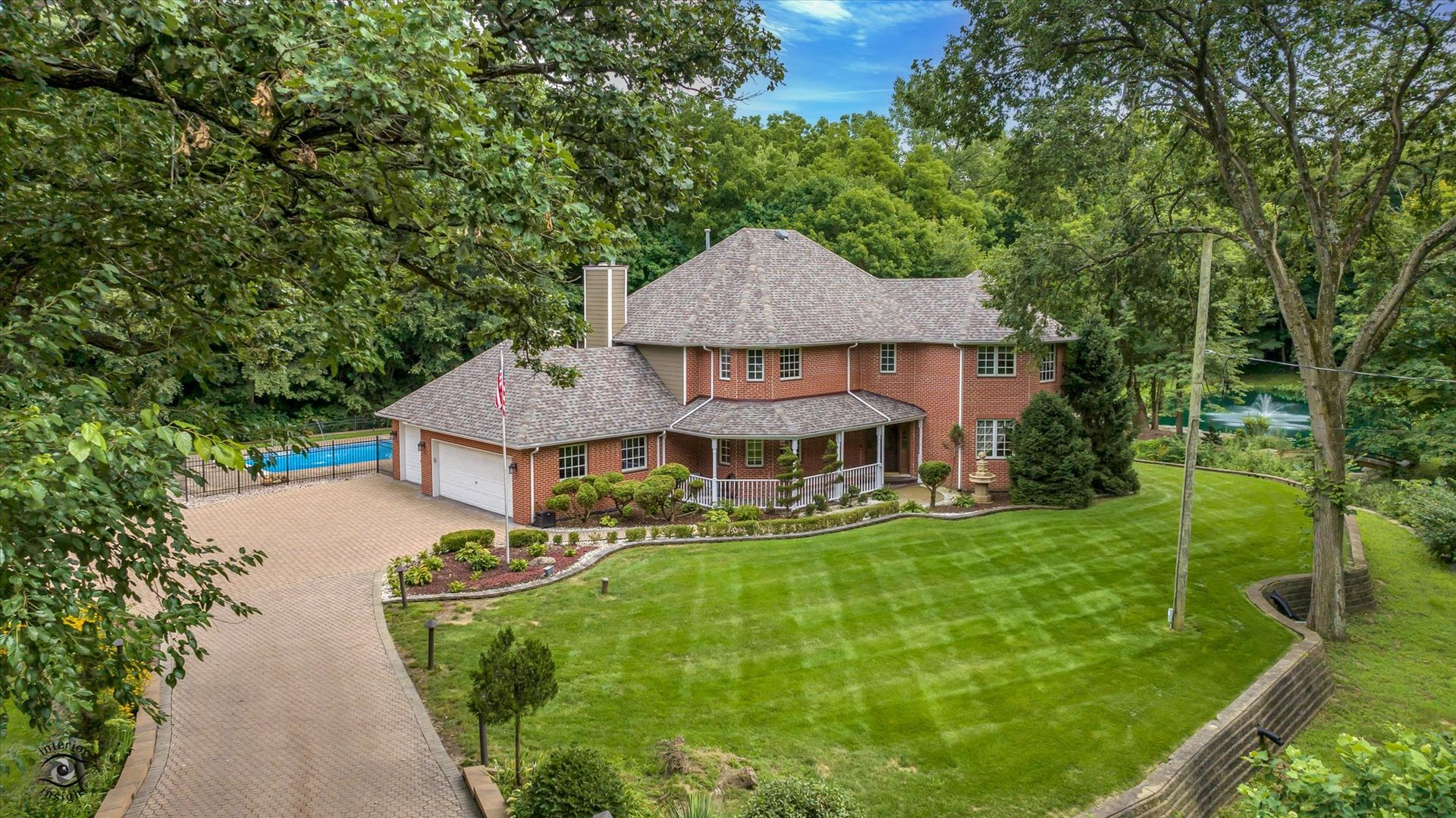 a aerial view of a house with swimming pool garden view and trees