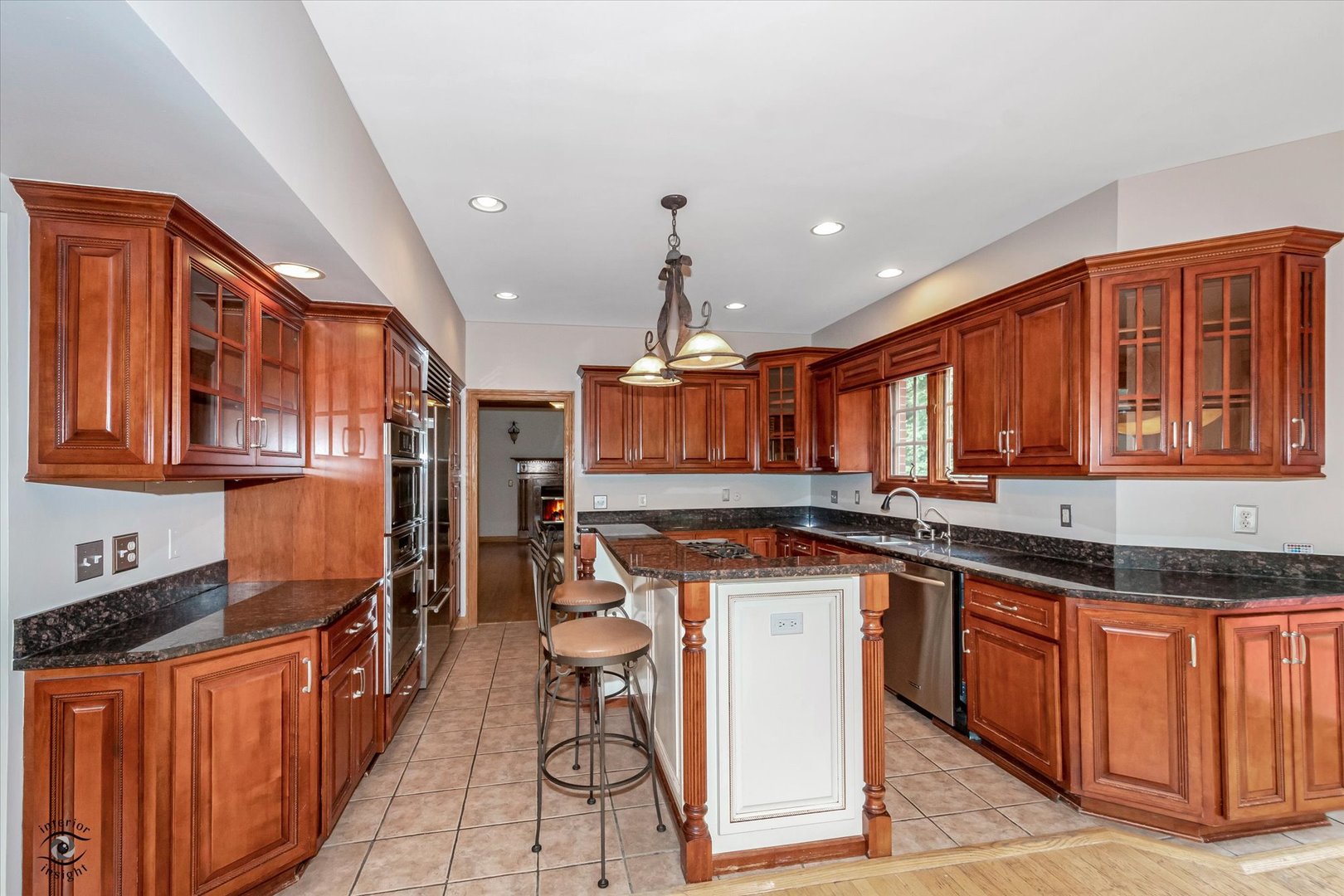 20841 Wolf Road Mokena, IL 60448 - Photo 20 of 40 a kitchen with stainless steel appliances granite countertop a stove a sink dishwasher and cabinets with wooden floor