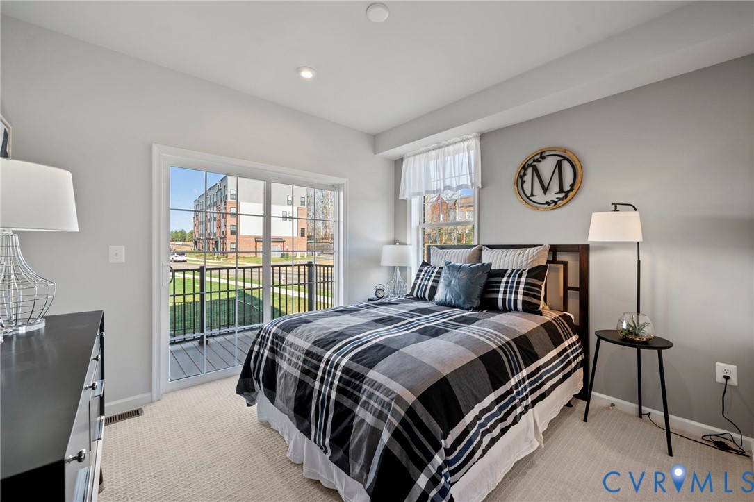 3609 Edna Path, Unit A Richmond, VA 23233 - Photo 23 of 26 a bedroom with a bed and a table