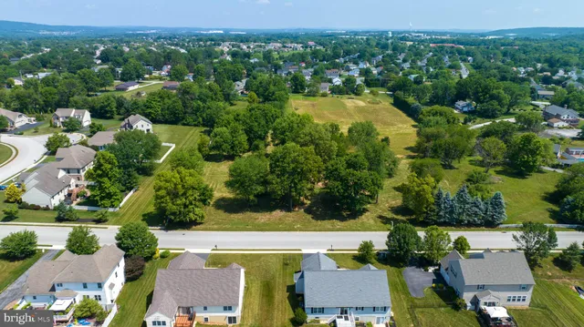 an aerial view of residential house with outdoor space and swimming pool