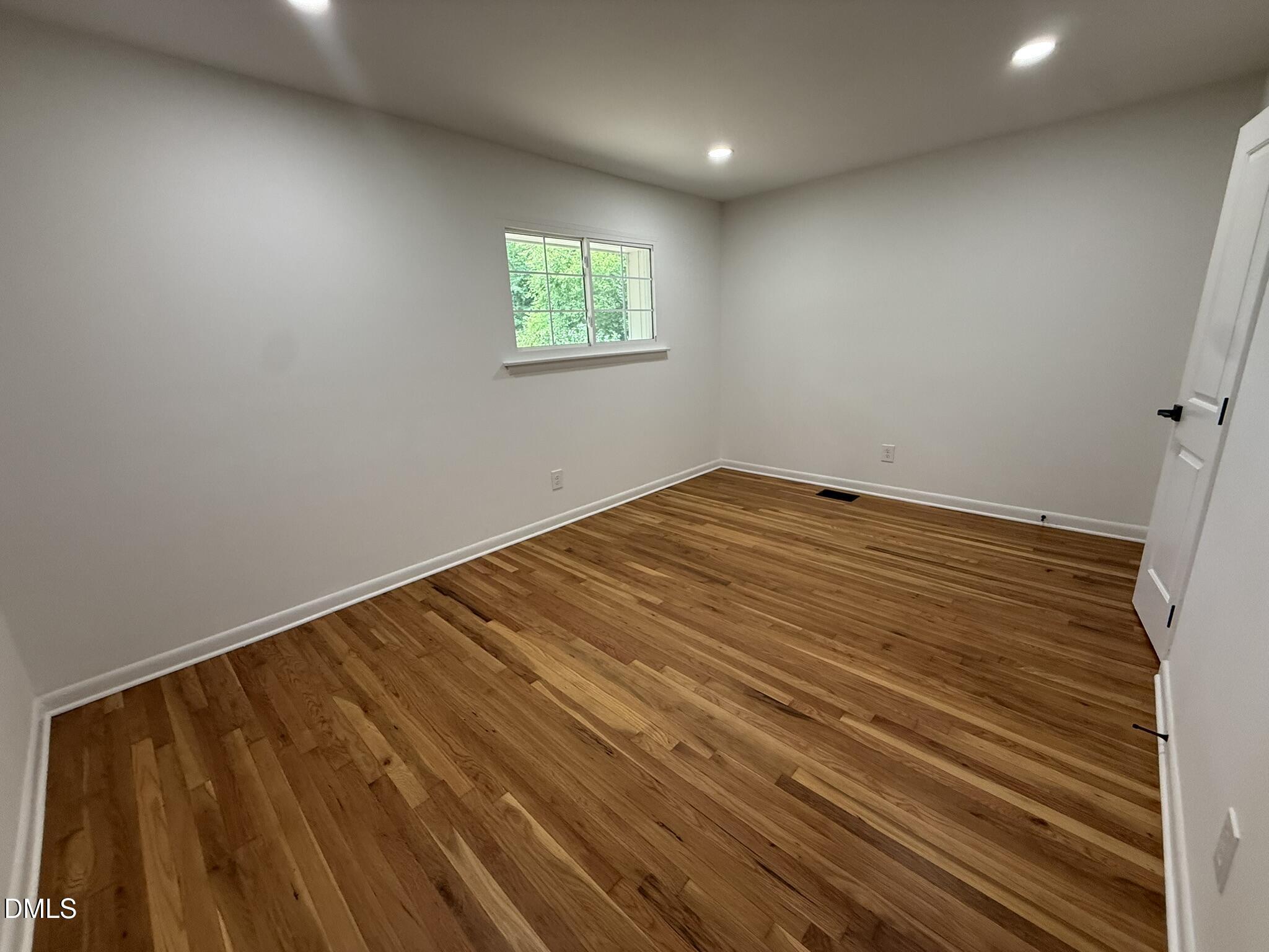 708 Hawes Court, Unit C Raleigh, NC 27608 - Photo 10 of 22 an empty room with windows
