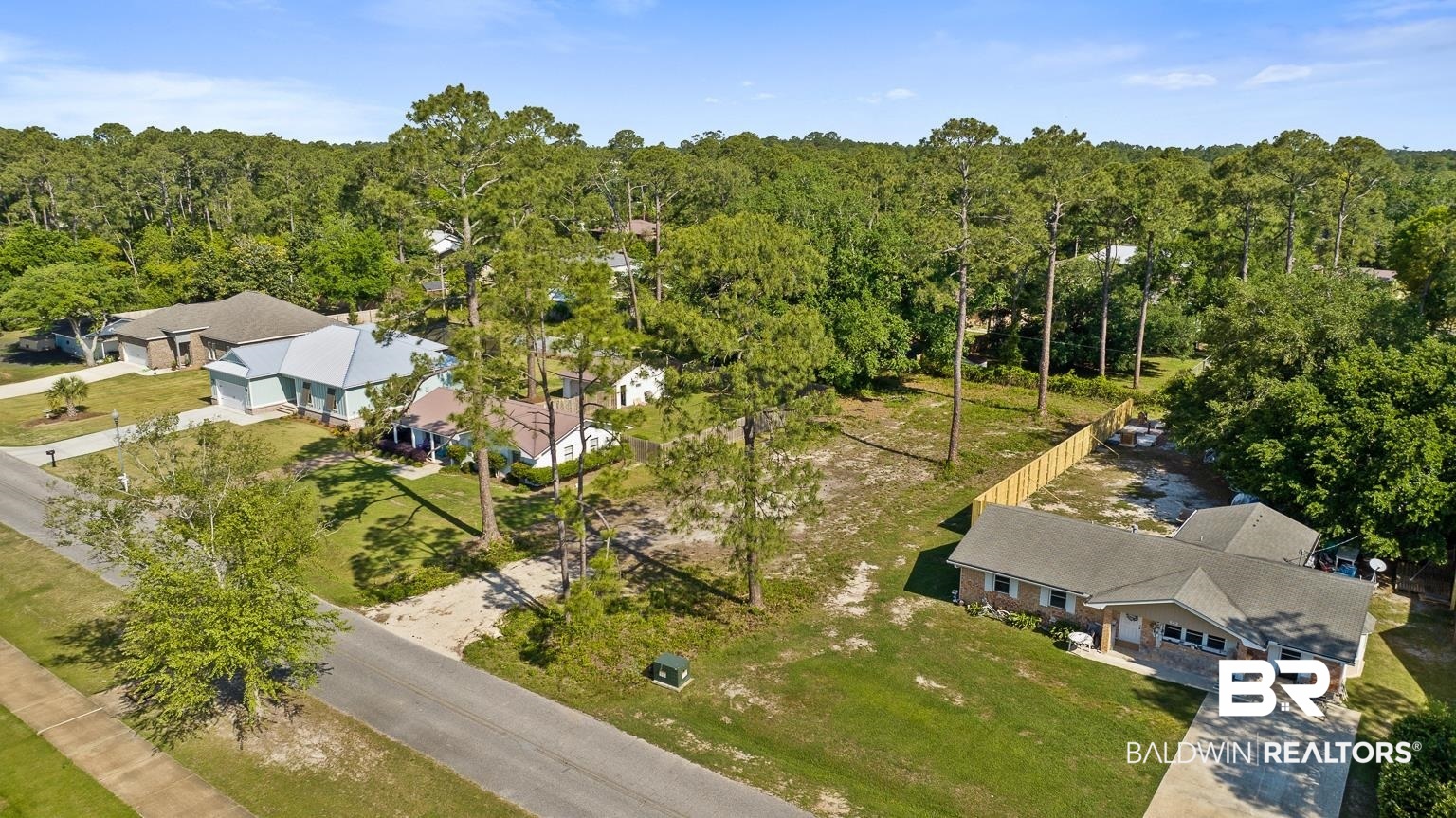 348 West 22nd Avenue Gulf Shores, AL 36542 - Photo 2 of 13 Birds eye view of property featuring a wooded view