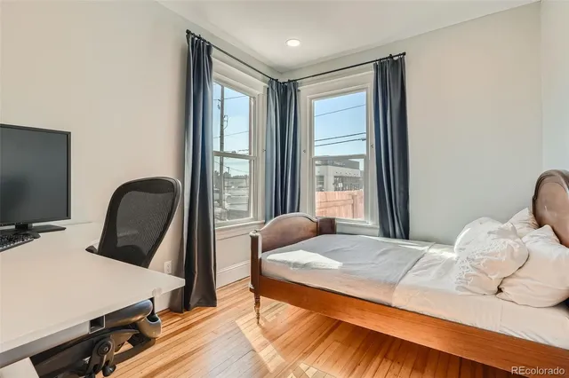 a bedroom with a bed and a large window