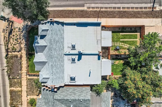 an aerial view of multiple houses with yard