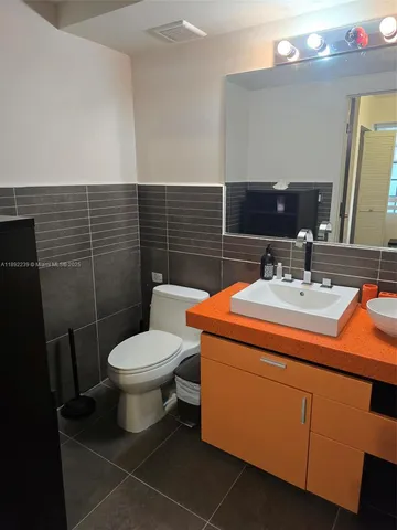 a bathroom with a sink toilet and mirror