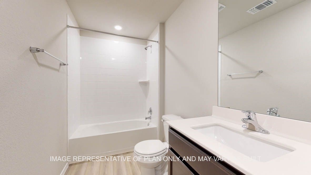 3016 Taddy Road Lorena, TX 76655 - Photo 25 of 29 a bathroom with a bathtub shower sink vanity mirror and toilet