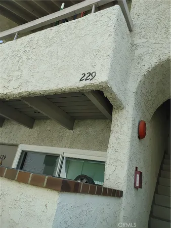 a living room with furniture a couch and a flat screen tv