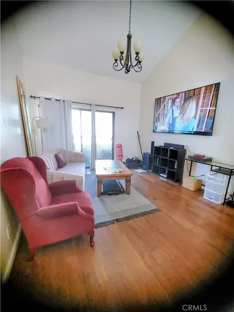 a room with stainless steel appliances kitchen island a table chairs and a refrigerator