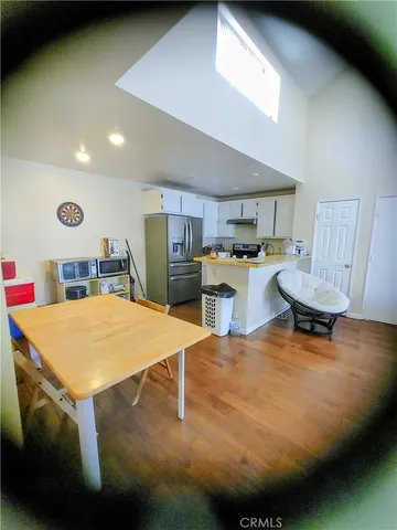 a kitchen with stainless steel appliances granite countertop a sink a stove and a refrigerator