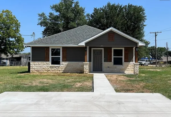 a front view of a house with garden
