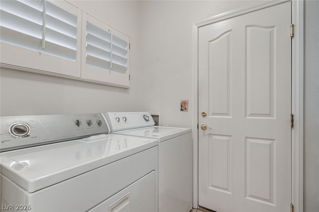 1479 Orange Jubilee Road Henderson, NV 89014 - Photo 29 of 36 A well-appointed laundry area with efficient appliances and practical window coverings.