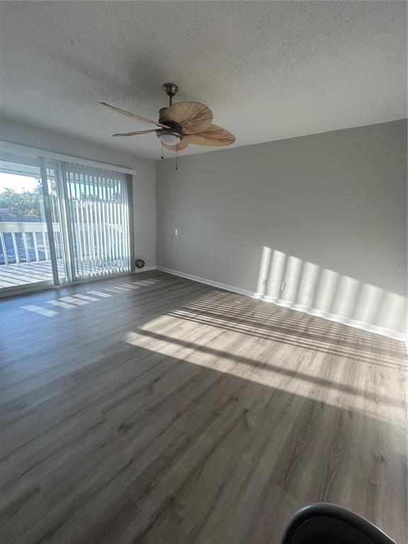 7006 Midnight Pass Road Sarasota, FL 34242 - Photo 6 of 12 a view of an empty room with wooden floor and a window