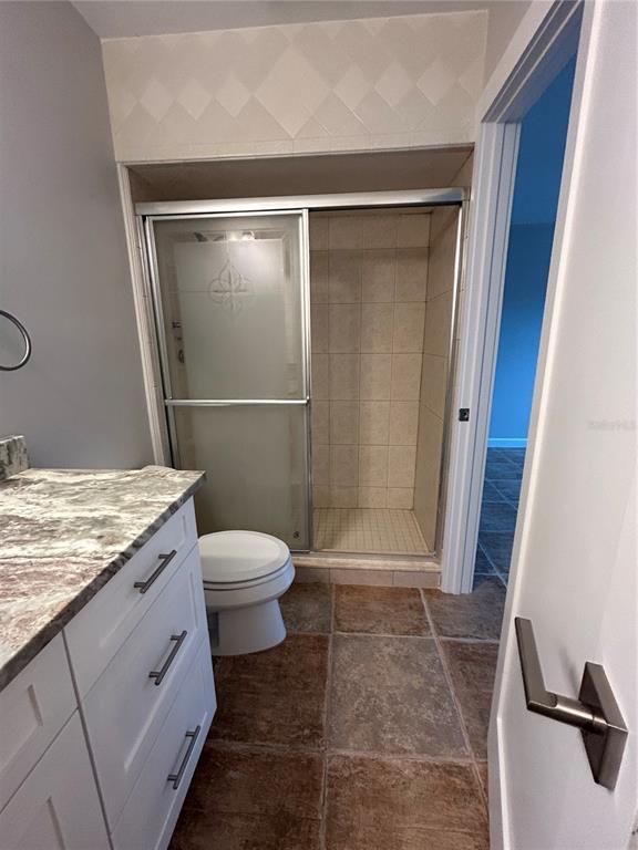 7006 Midnight Pass Road Sarasota, FL 34242 - Photo 8 of 12 a bathroom with a granite countertop sink toilet and shower