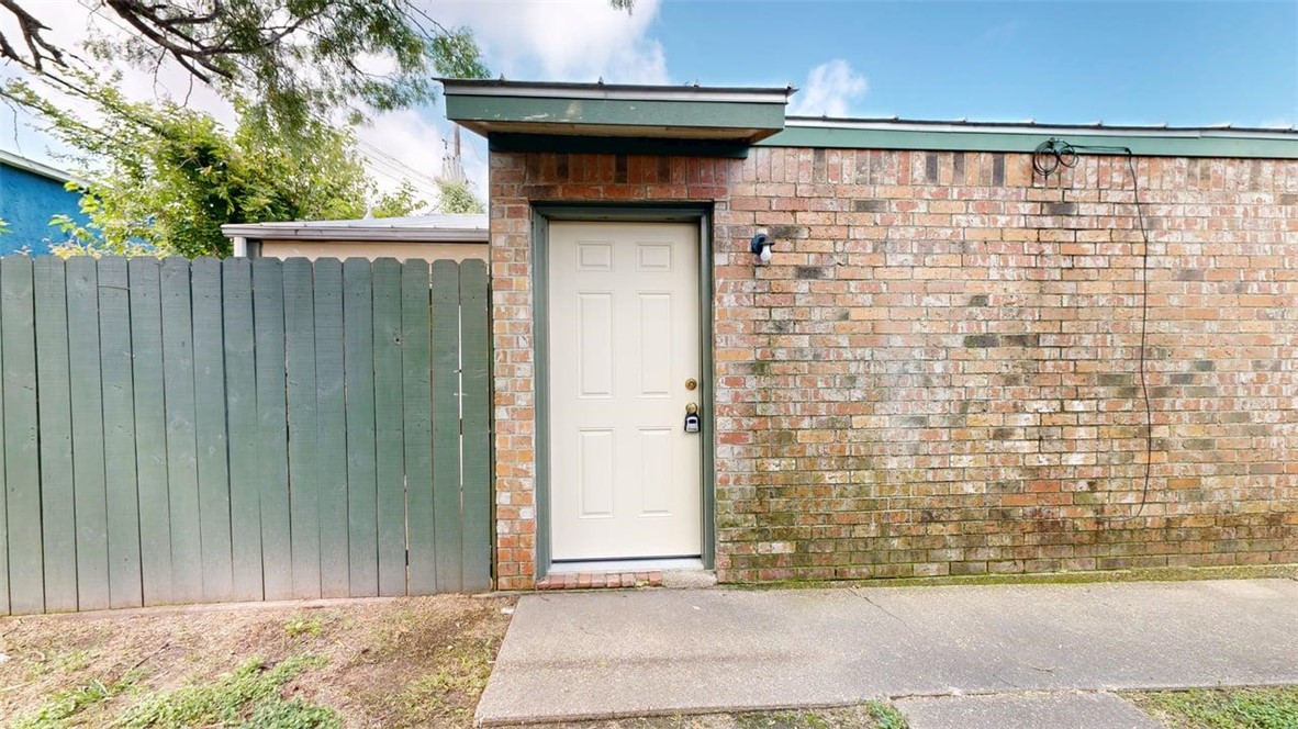 Property entrance with brick siding