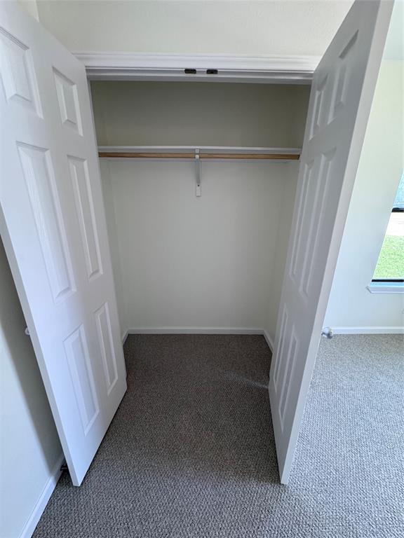 1736 Ransom Terrace Fort Worth, TX 76112 - Photo 13 of 27 Closet with bi-fold doors, interior hanging rod, and carpet flooring this is closet for second bedroom
