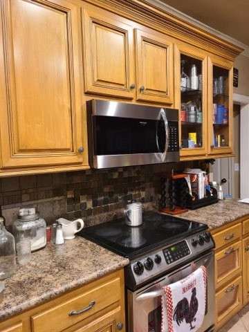 14 North George Road Flintville, TN 37335 - Photo 12 of 48 a kitchen with granite countertop a stove a sink and a microwave