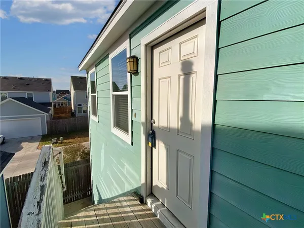 a view of a house with car parked