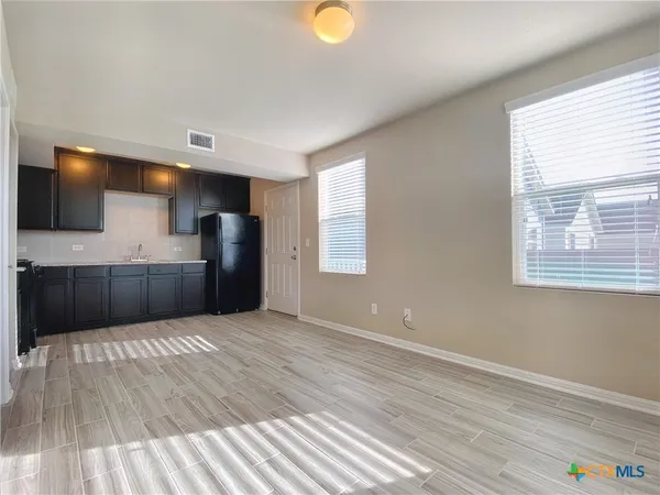 a view of kitchen with a sink cabinet and a window