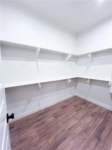 a view of a room with wooden floor