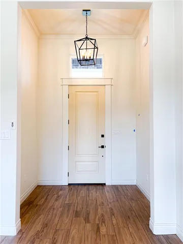 a view of a hallway with wooden floor and closet