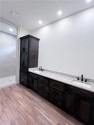 a spacious bathroom with a double vanity sink and a mirror