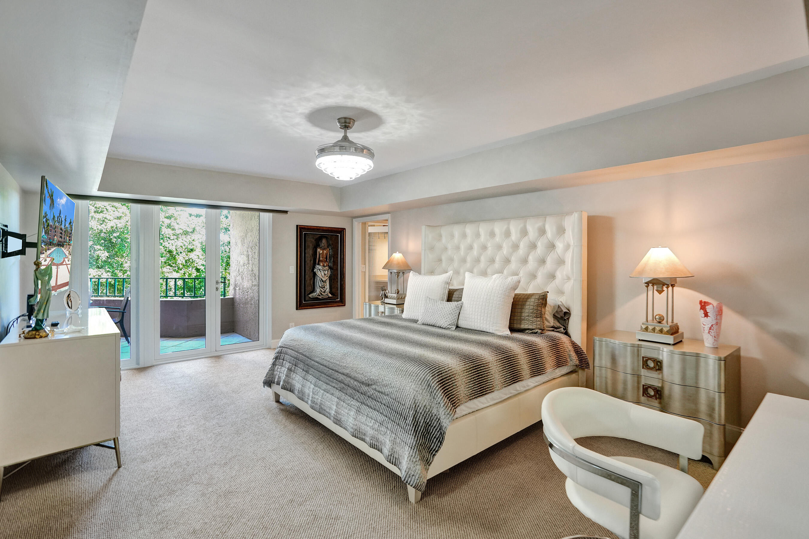 100 Southeast 5th Avenue, Unit 406 Boca Raton, FL 33432 - Photo 11 of 34 a spacious bedroom with a bed and a large window