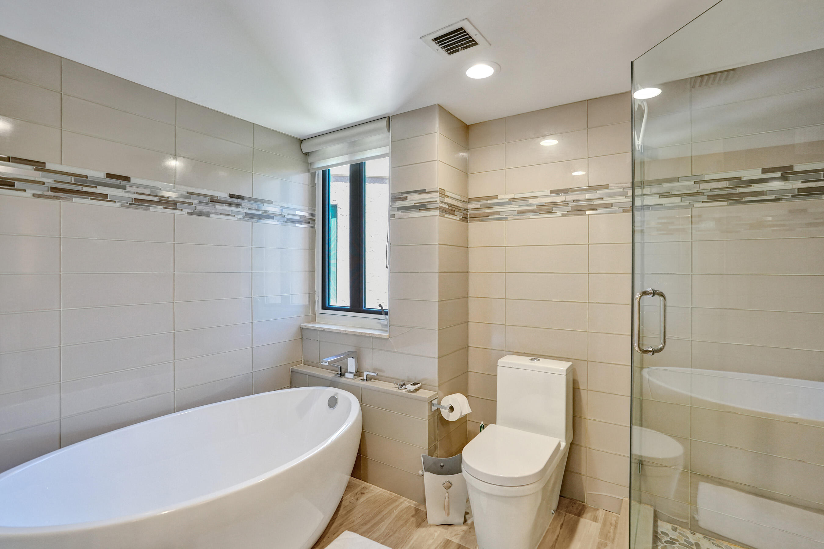 100 Southeast 5th Avenue, Unit 406 Boca Raton, FL 33432 - Photo 13 of 34 a bathroom with a bathtub toilet and shower