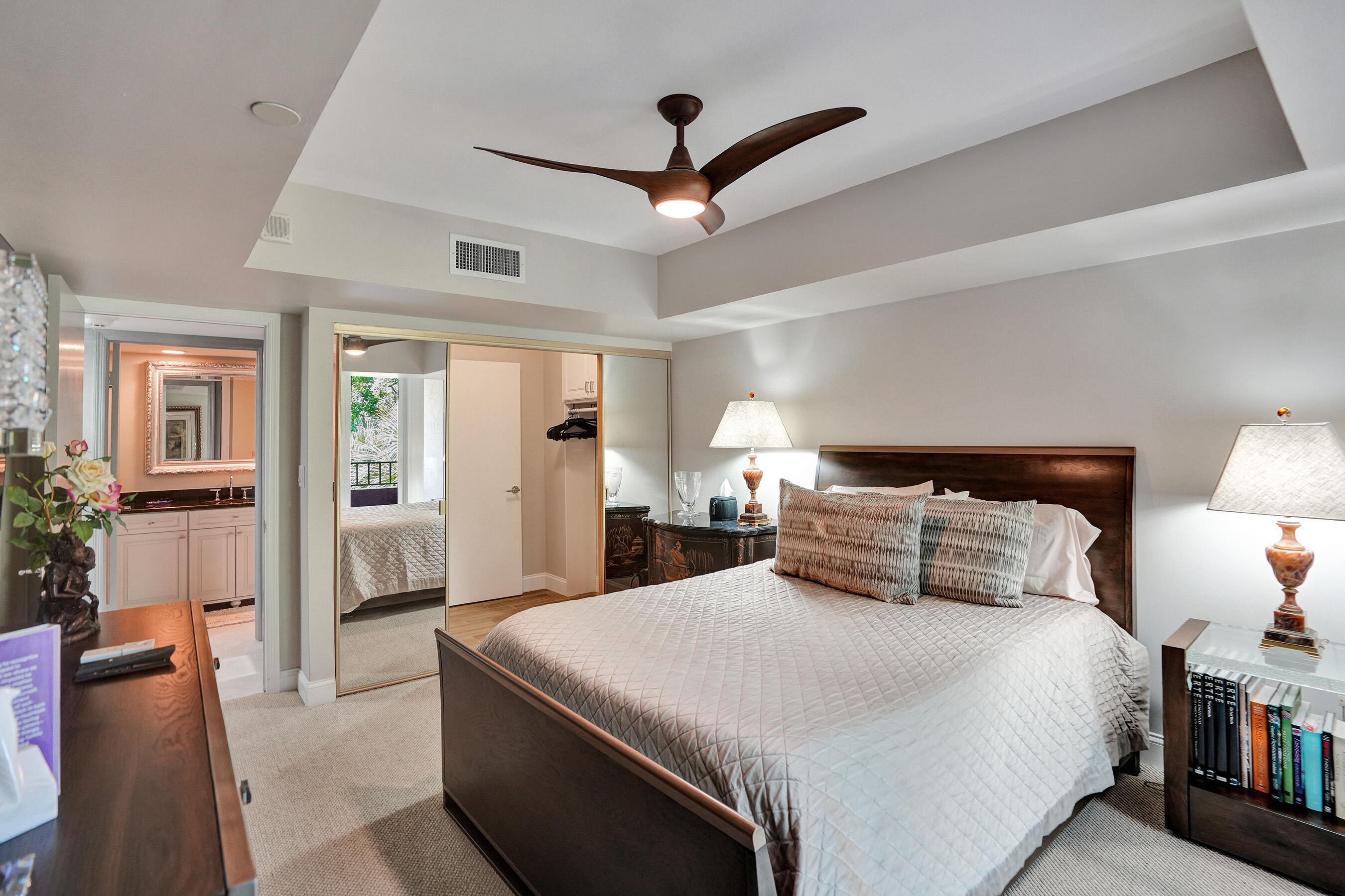 100 Southeast 5th Avenue, Unit 406 Boca Raton, FL 33432 - Photo 16 of 34 a bedroom with a large bed and a chandelier