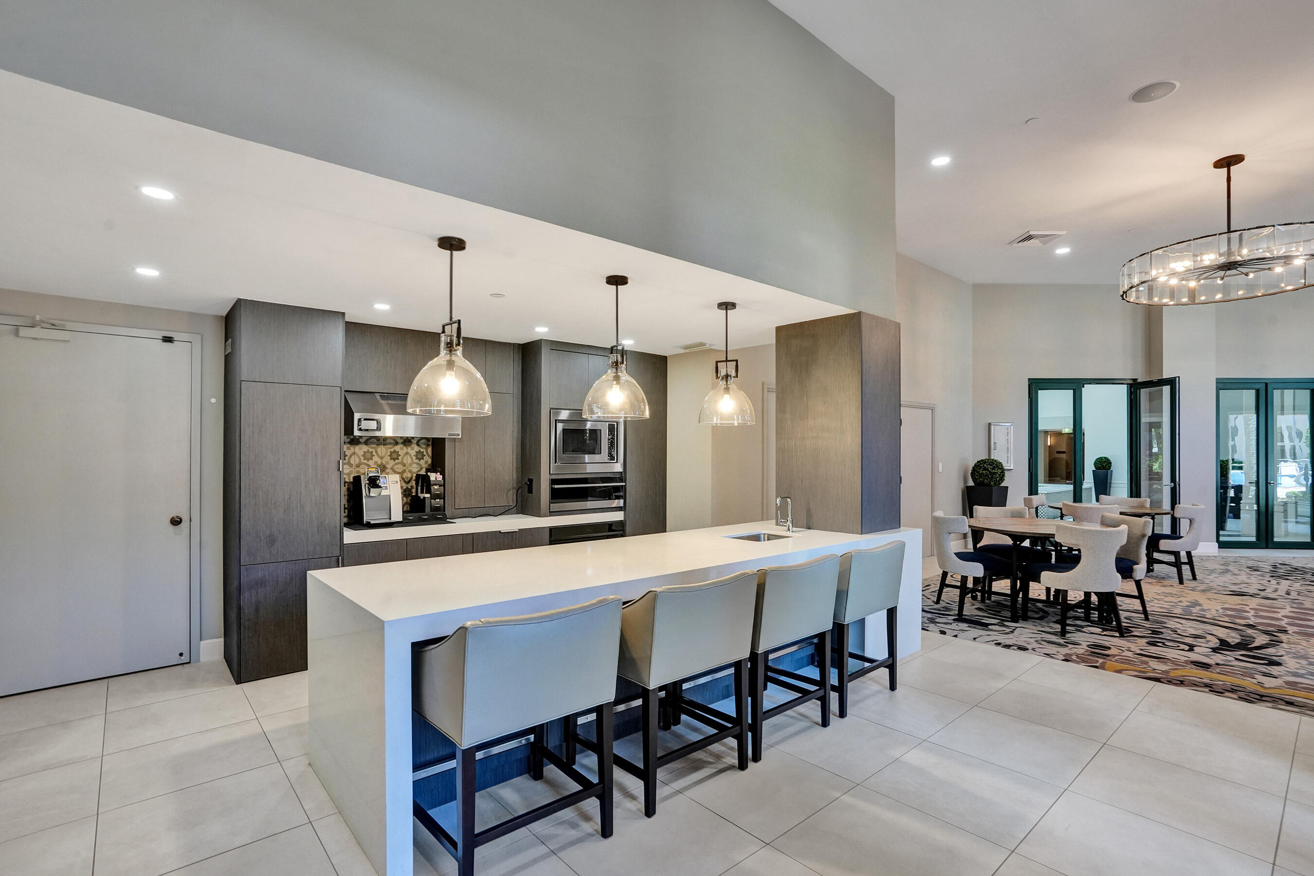 100 Southeast 5th Avenue, Unit 406 Boca Raton, FL 33432 - Photo 29 of 34 a large kitchen with a table and chairs