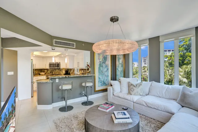 a living room with furniture and a chandelier